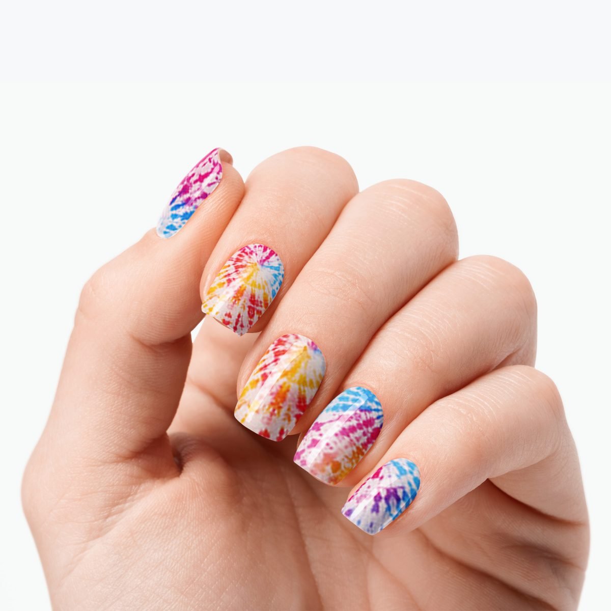 Velvora Tie-Dye semi-cured gel nail strips on a hand with colourful summer swirl nails