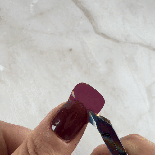 Step 3, trimming and filing the excess Velvora gel strip to shape